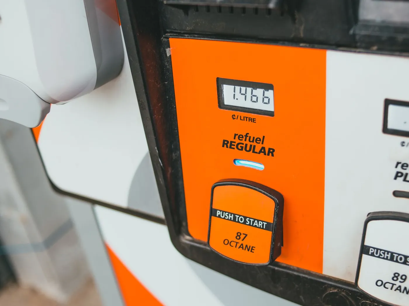 Close-up of a gas pump display showing grade buttons and the price per gallon.
